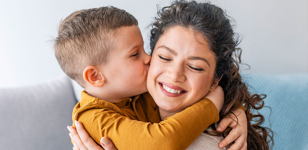 child kissing mother