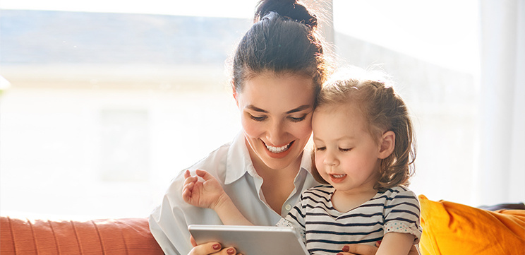 mum and daughter looking at ipad