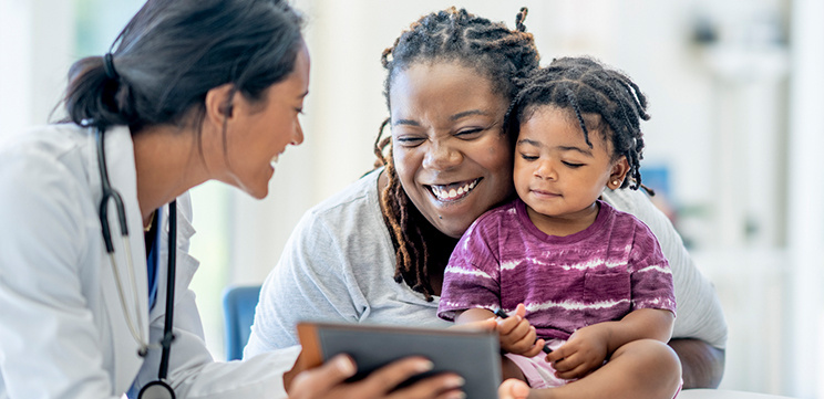 woman and toddler consulting with doctor