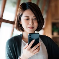 young woman checking messages on mobile phone