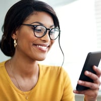 young woman checking messages on mobile phone